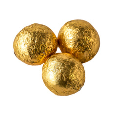 Solid milk chocolate balls in gold foil